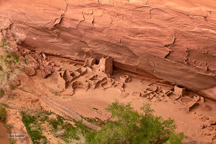 Ancient ruins at the base of a cliff face in Canyon de Chelly