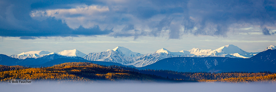Low clouds and dense fog in the valley give the appearance that the mountains are sandwiched between them.