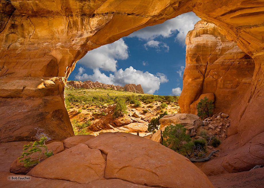 The sandstone fins of the Fiery Furnace are seen in the distance, approximately 1.2 miles away as viewed through Broken Arch....