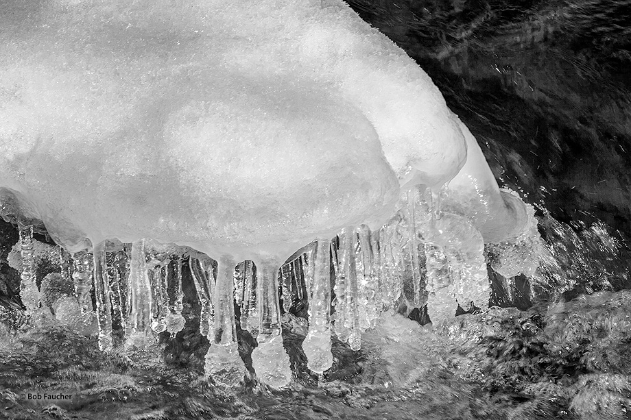 A snow hummock in the North Fork of the Teanaway river is ringed with icicles resembling the crystal pendants of a chandelier