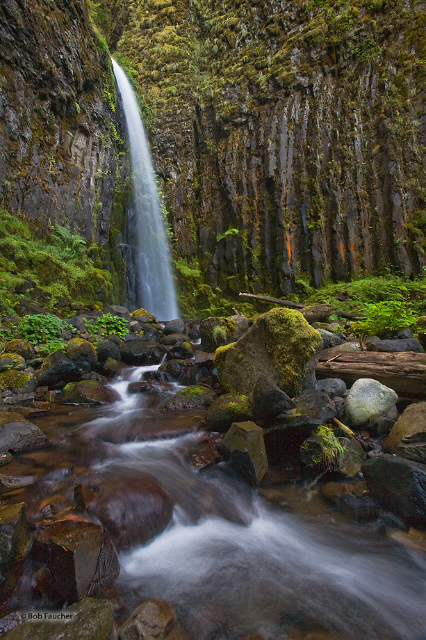 This lovely falls drops through a thinner spot in a large flow of columnar basalt then wends its way through boulders, forming...