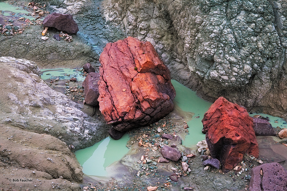 Turtle Cove strata, a striking blue-green rock layer produced by millions of years of volcanic ash accumulation, when admixed...