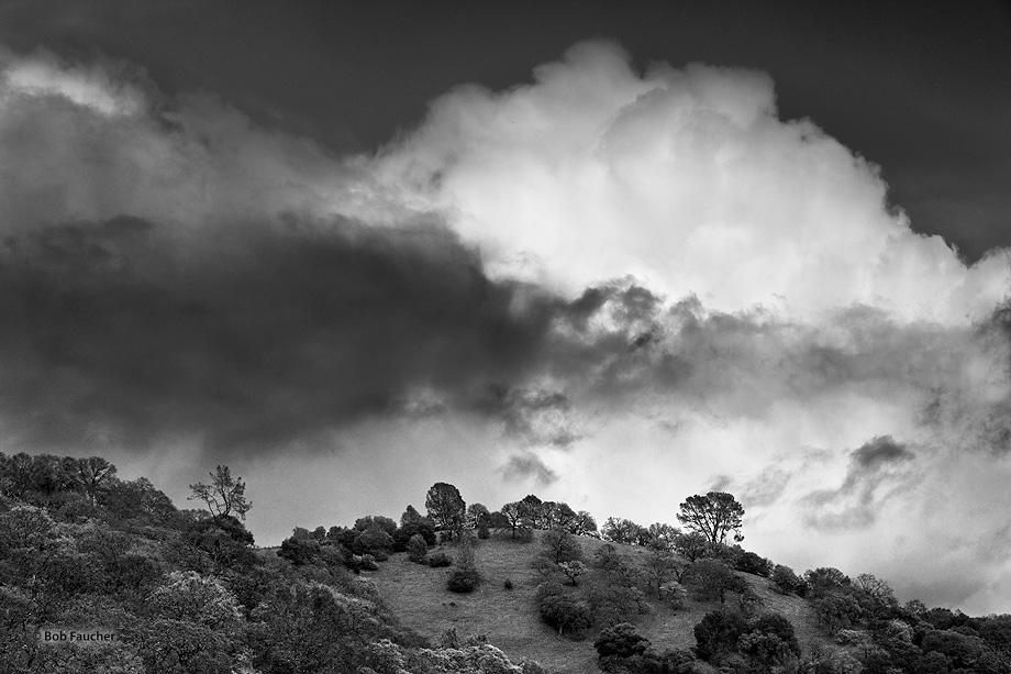 Afternoon thunder clouds from the east build over the hills flanking High Valley, above ClearLake, in Lake County, California