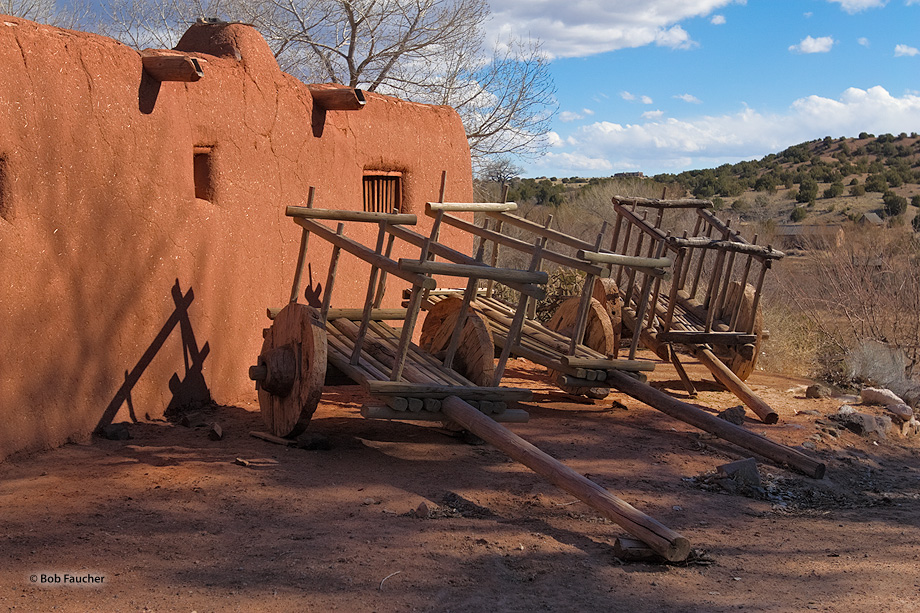 Horse-drawn carts ouside the fortified walls of the central plaza of El Rancho de las Golondrinas, a living history museum