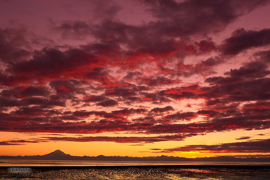 Shortly after the sun's disc dropped below the horizon formed by the Chigmit Mountains the warm red, orange and yellow wavelengths...