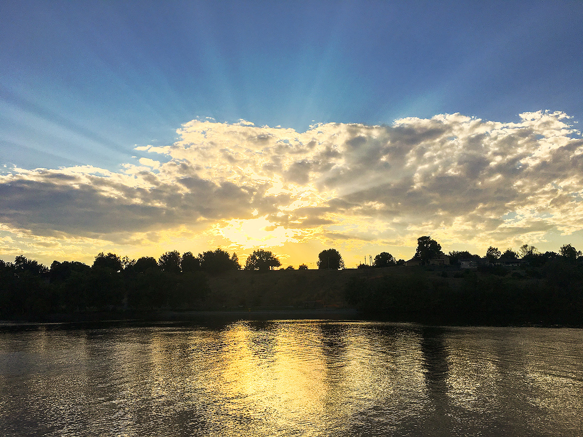 Early Fall sunset behind Clarkston, Washington, as seen from across the Snake River, producing widely-spread crepuscular rays...