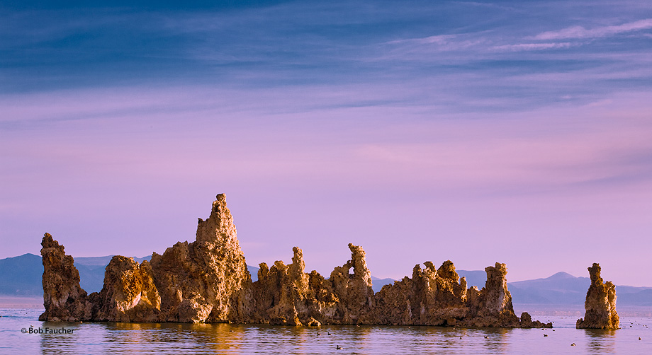 The sky, lake and tufas all reflect various amounts of the magenta light as the morning sun rises inexorably