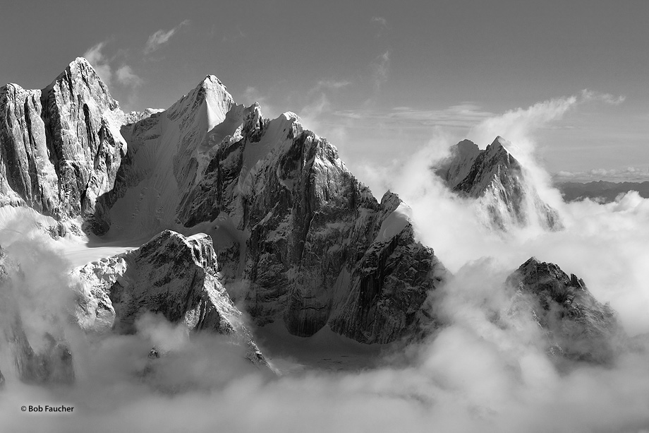 Ramparts on Denali and the Moose's Tooth emerge through cloud cover