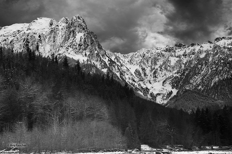 Mount Index appears above the Index River as storm clouds form behind her