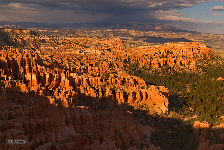 A late afternoon storm, positioned over the Aquarius Plateau in the background, forms a dramatic backdrop to the hoodoos and...