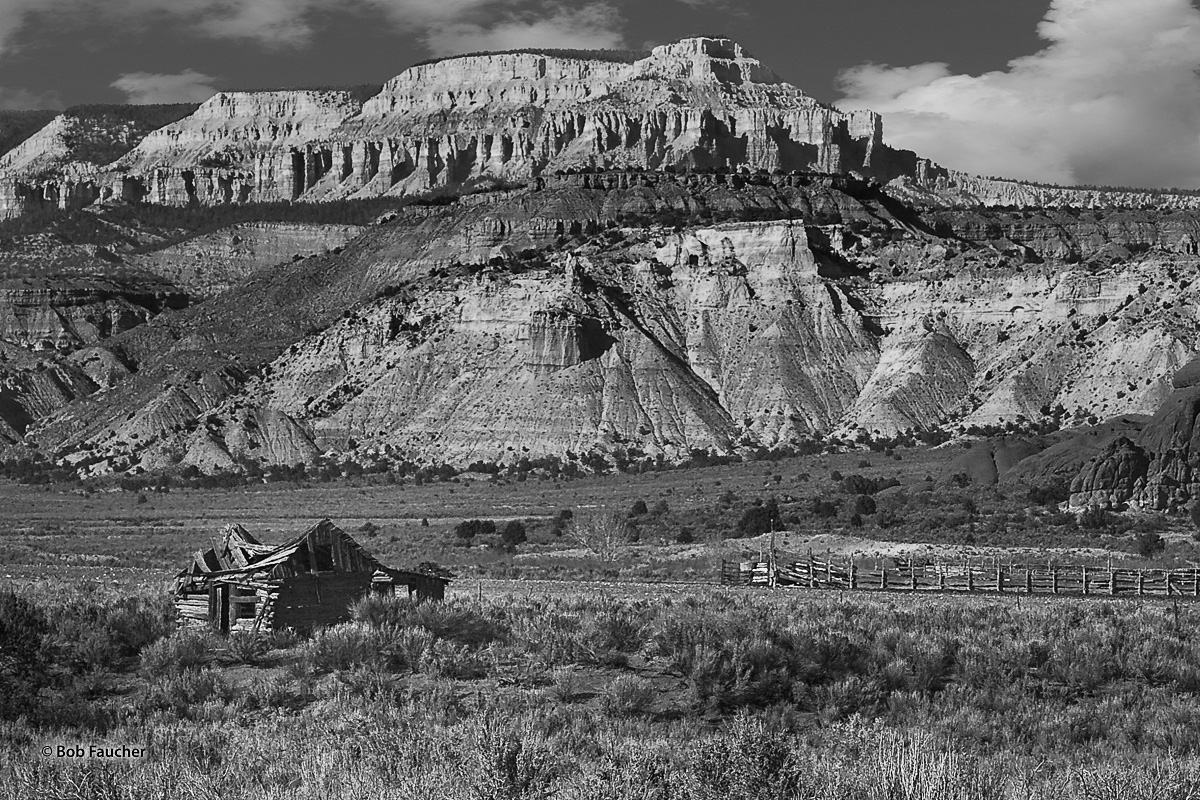 Collapsing cabin and adjacent large corral, all appear small by comparison to Aquarius Plateau, dominant in the background. Peaking...