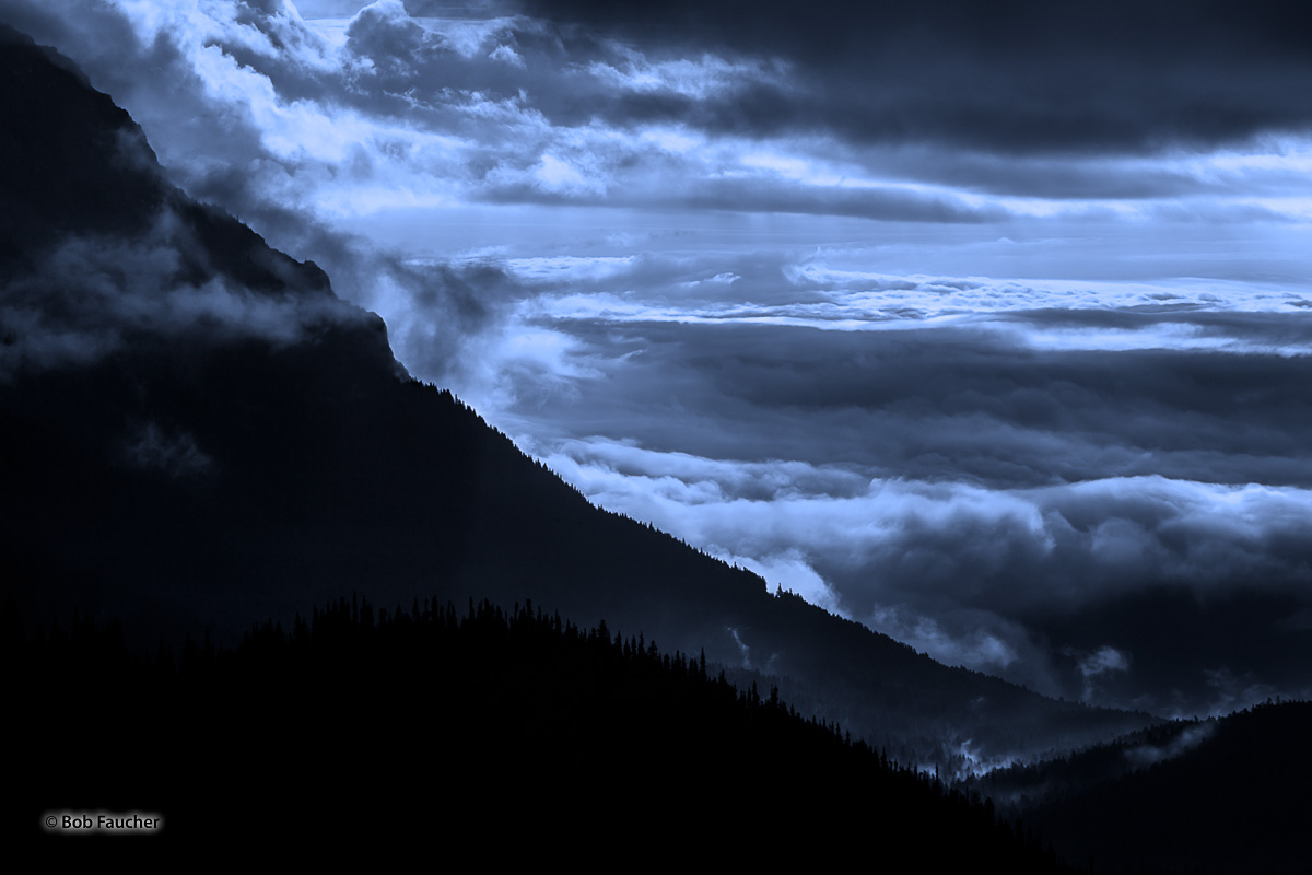Layers of mountain ridges are engulfed in layers of clouds and fog in the early morning along Hurricane Ridge.