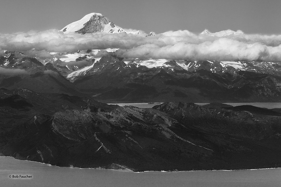 Rising from the shore of Chinitna Bay in the middleground, this dormant stratovolcano towers above the Chigmit Mountains, an...