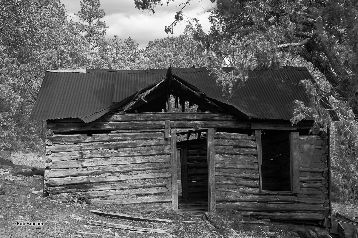 An abandoned cabin encountered along the way to Pecos Pueblo Mission in New Mexico. Corrugated, galvanized metal roofing has...