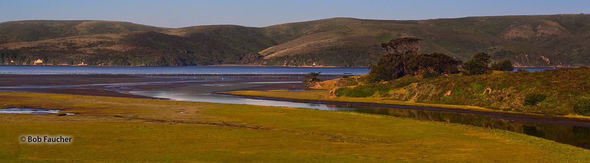 Early morning light on the tidal estuary at Tomales Bay with the rolling hills of Point Reyes along the far shore.