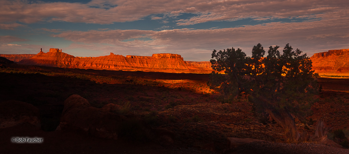 As seen from Fisher Towers, morning light streams across Richardson Amphitheater in Professor Valley highlighting Refrectory...