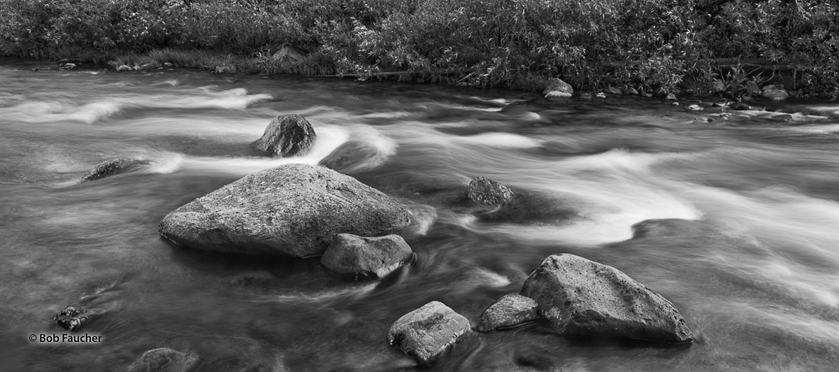 Silky smooth rapids, the result of a long exposure, contrast markedly with the immovable rocks in the San Juaquin river in Devil...