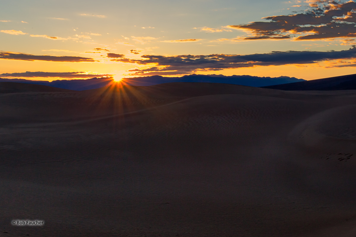 Sunrise over the Amargosa Range in Death Valley begins to light the Mesquite Flat Dunes