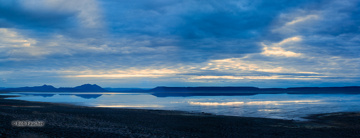 Recent heavy snowmelt runoff has enlarged the lake in the floor of the Alvord Desert. Early morning Blue Hour, with the warm...