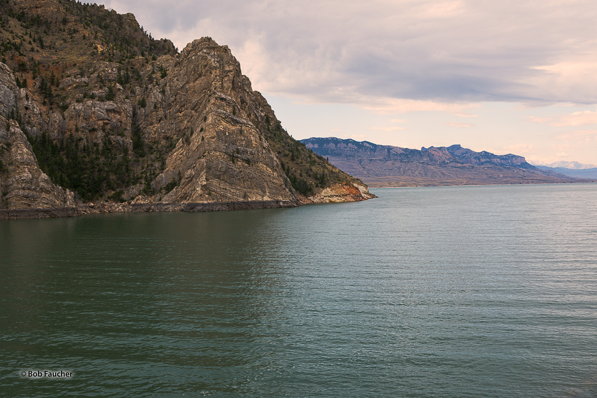 The mountains of the Absaroka Range dominate the scenery that surrounds Buffalo Bill Reservoir. Shoshone Canyon, the location...