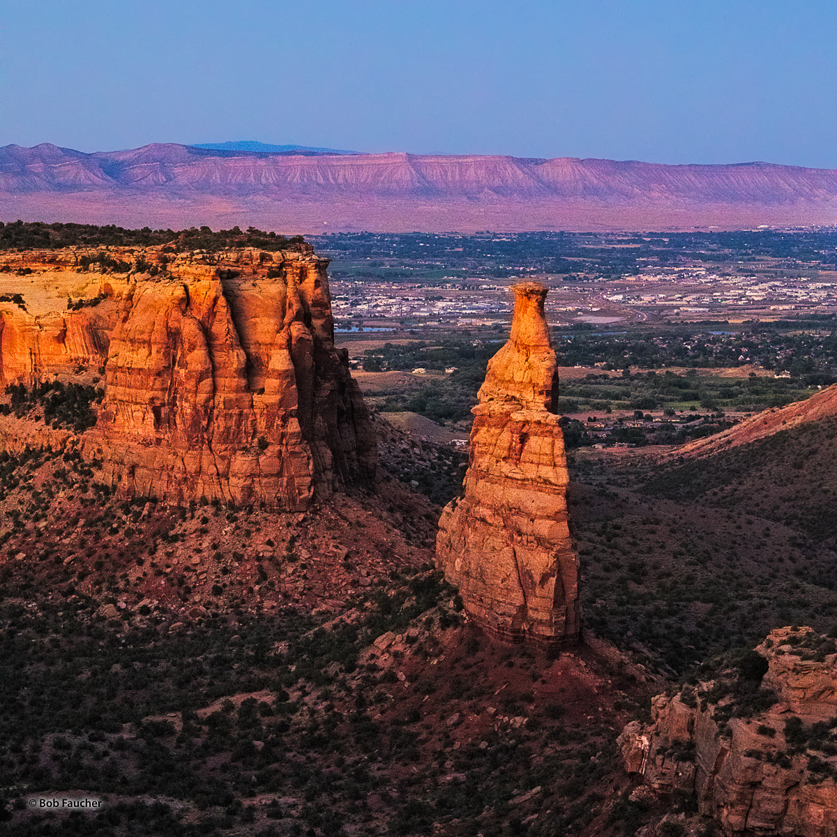 Independence Monument, glowing with the warm light of dusk, is perhaps the most impressive rock formation found in Colorado National...