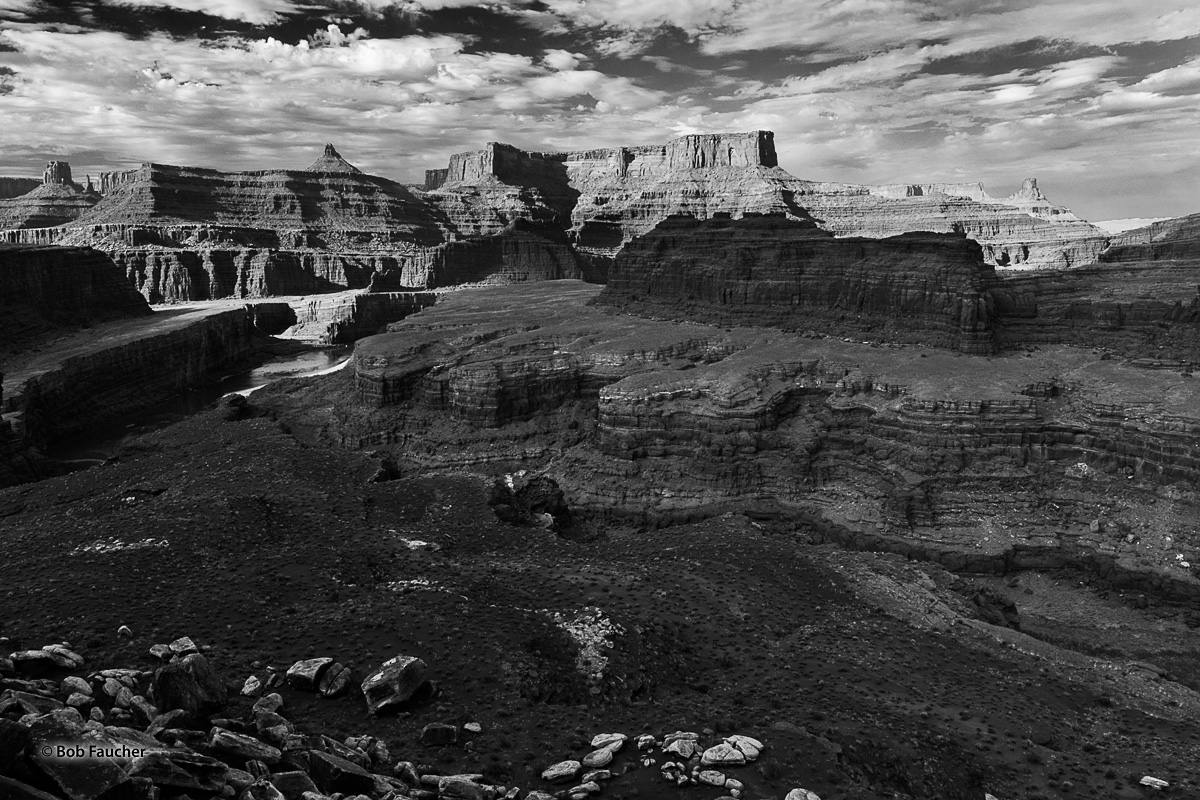 Afternoon light casts shadows in side canyons along the Colorado River as it passes in the still strongly-lit main channel. High...