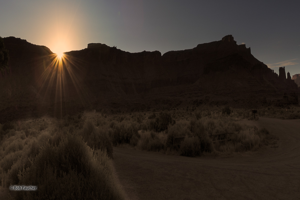 Sunrise breaks over Sevenmile Mesa, east of Richardson Amphitheater. To the extreme right of the image and still in deep shadows...