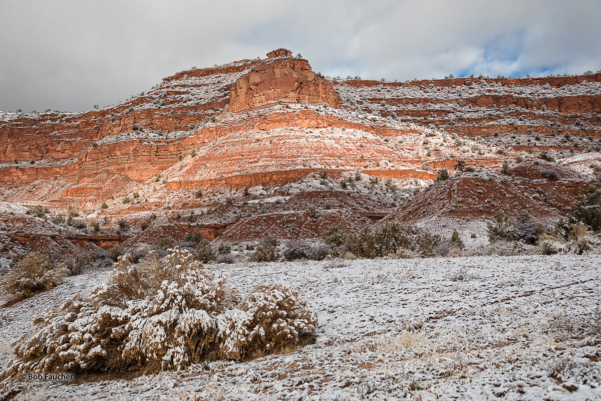 Savage point, highlighted on the red cliffs of Grand Plateau above Kanab Utah, with streaks of fresh snow from the previous night...
