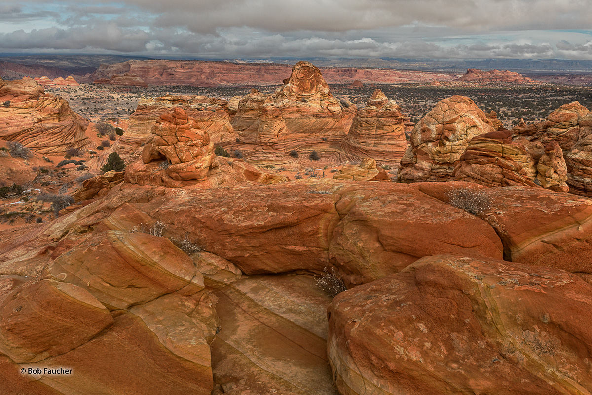 Teepee formations in south Coyote Buttes with Vermillion Cliffs in the background.