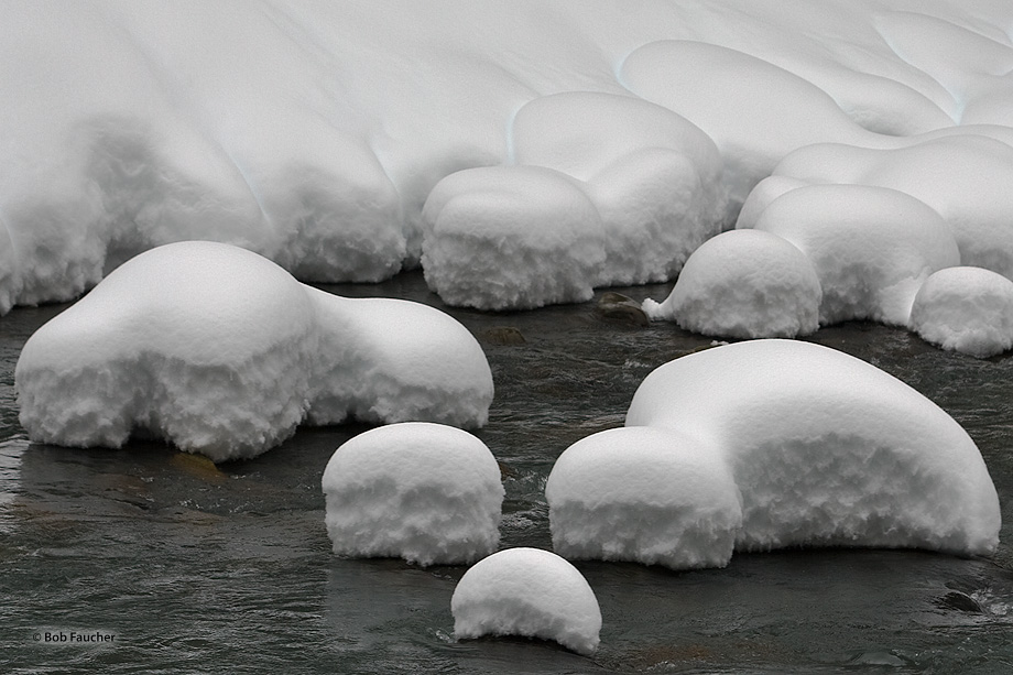 Snow hummocks on rocks in the river take on the shapeless form of shmoos, the armless pear-shaped character introduced by cartoonist...