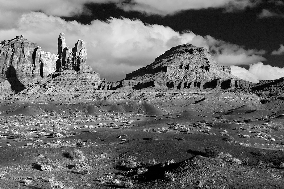 Setting Hen is a rock formation west of Monument Pass in Monument Valley. Eagle Mesa is on the left; Sleeping Bear on the right...