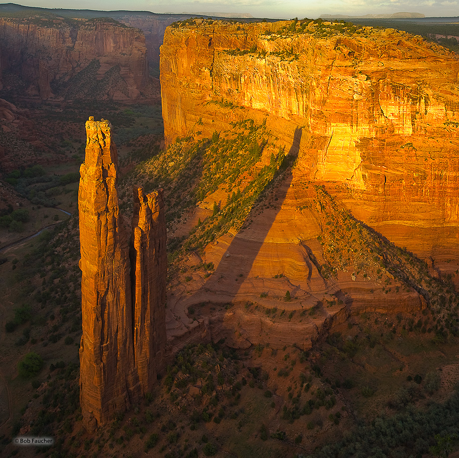 Sunset lights up Spider Rock and the canyon wall to the east in Canyon de Chelly, the second largest canyon in the US. This feature...
