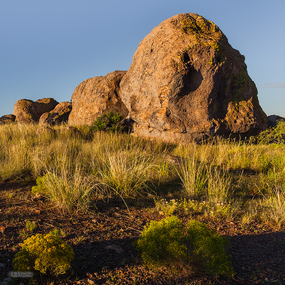 Morning light catches some boulders with its first rays. The "city" is a geologic formation made up of large, sculptured rock...