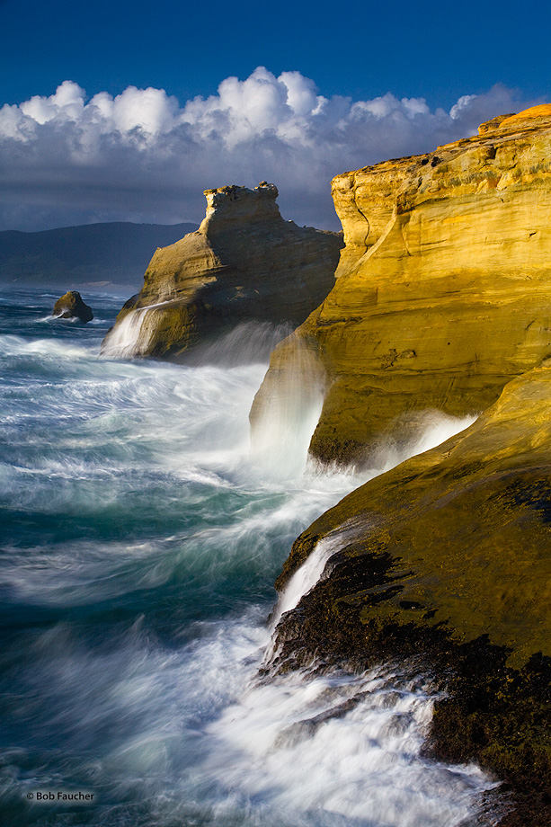 The headlands of Cape Kiwanda have troughs formed in their walls as the surf swells line up to fuel the continuous erosion