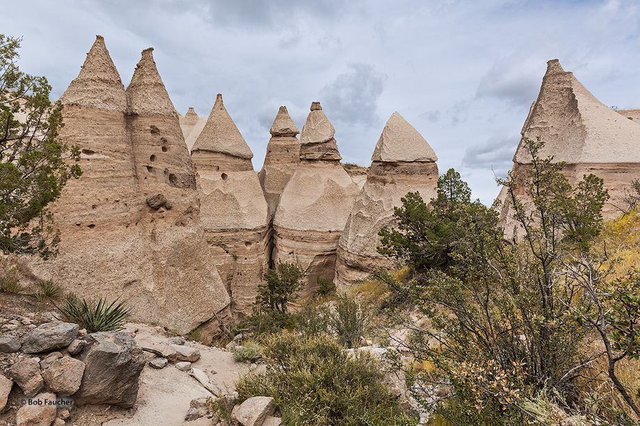 Precariously perched on many of the tapering hoodoos are boulder caps that protect the softer pumice and tuff below. Some tents...