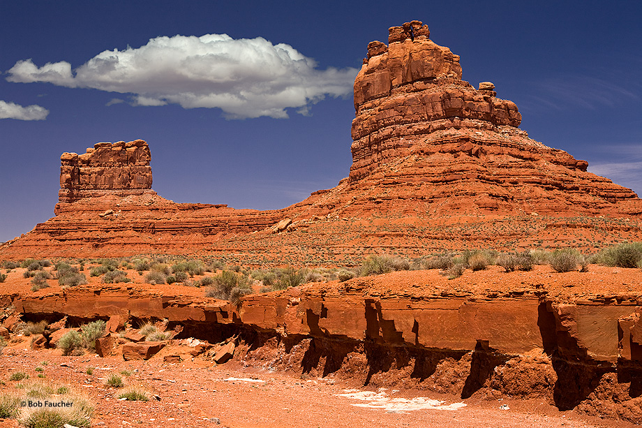 This formation of sandstone, with the blocks jutting out from below and the cloud appearing over the rear-most butte, reminded...