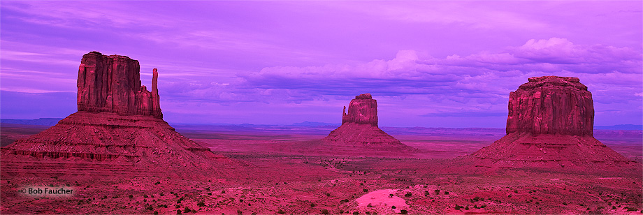 East and West Mitten and Merrick Buttes, seen here at twilight, are distinctive geological features found within Monument Valley...