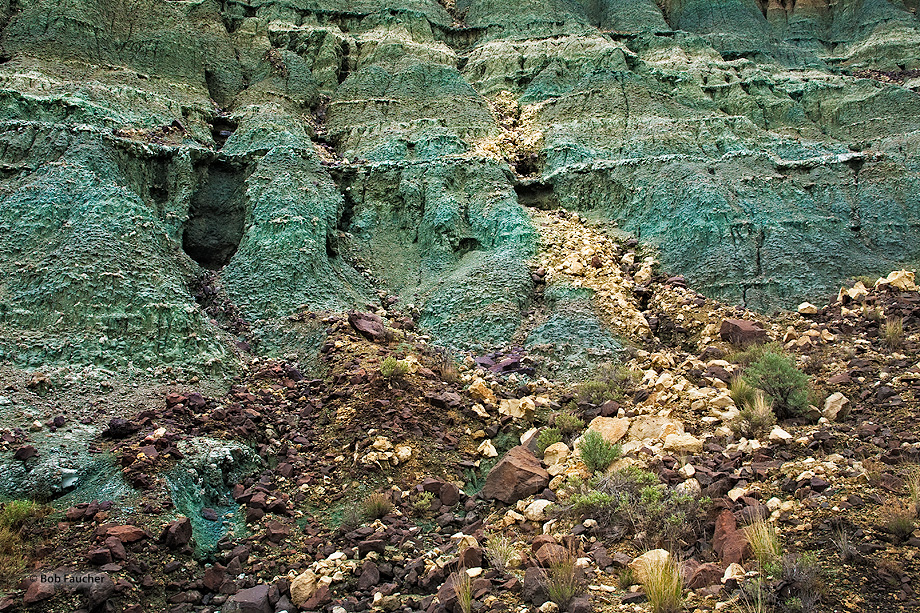 Turtle Cove strata, a striking blue-green rock layer produced by millions of years of volcanic ash accumulation. Ignimbrites...